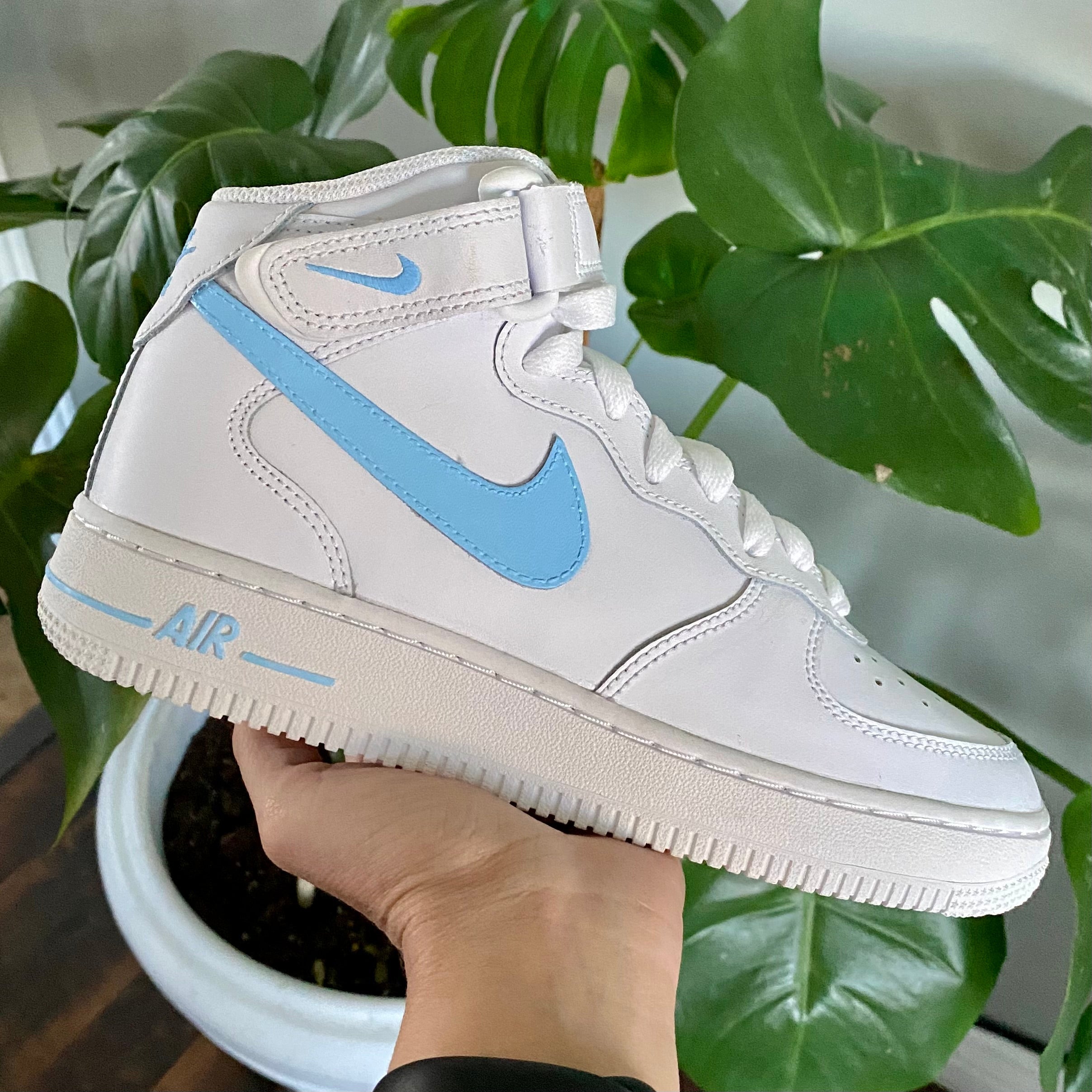 Custom Air Force 1s with light blue and navy 3D Nike Swoosh